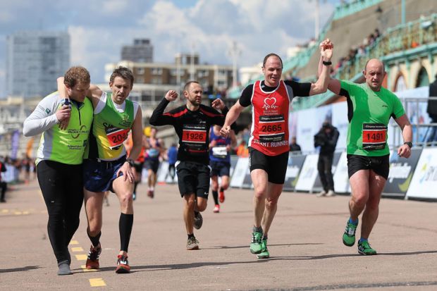 Runners crossing the finish line, Brighton Marathon 2016