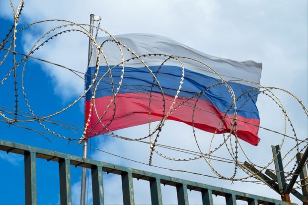 The Russian flag behind barbed wire