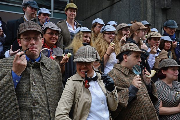 People dressed as fictional detective Sherlock Holmes gather in central London on July 19, 2014 illustrating academic detective work, plagiarism