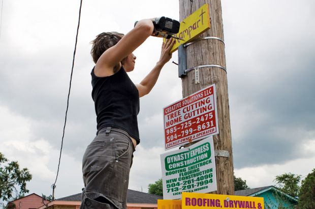 Woman puts up sign