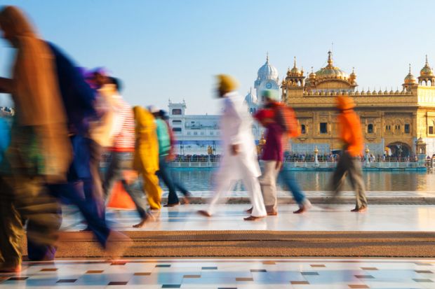 Sikh pilgrims walking past Golden Temple in India