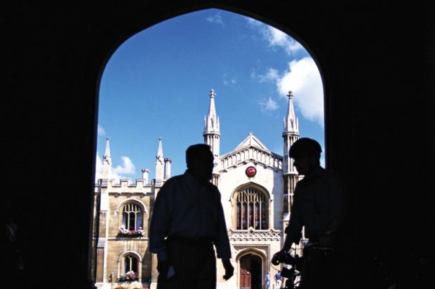 Silhouettes of men standing in university entrance