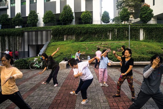 People practise tai chi in Singapore