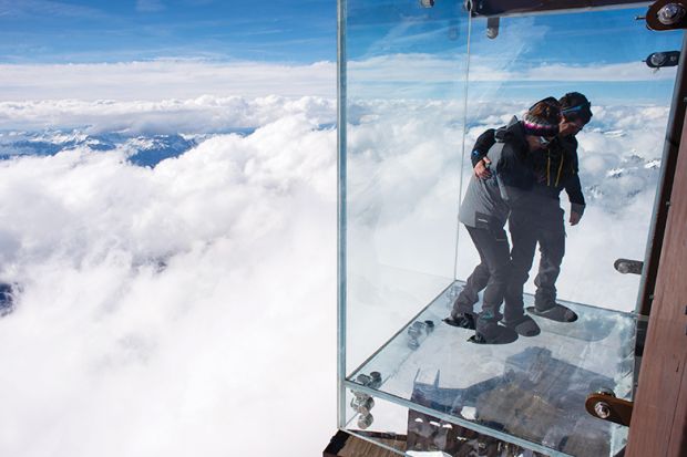 People standing on a glass viewing platform