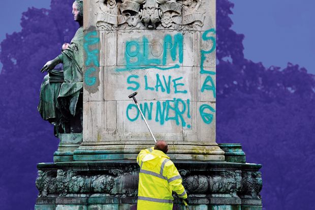 Council workers clean a statue of Queen Victoria in Woodhouse Moor Park in Leeds, 2020