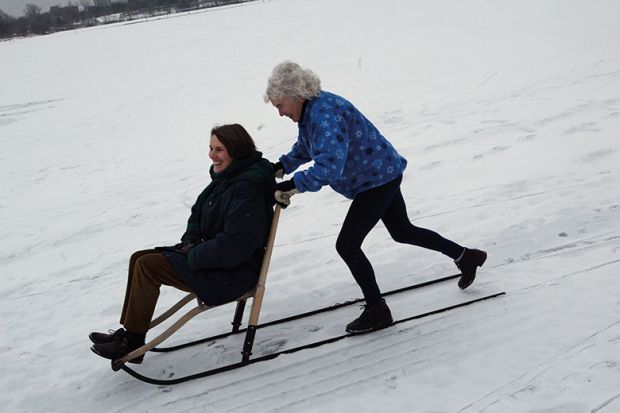 Two women on sledge