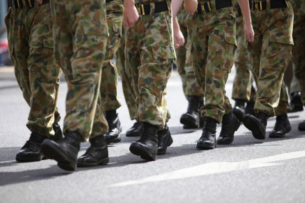 Soldiers in camouflage fatigues marching