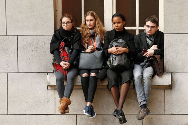 Sorbonne University students sitting on window ledge