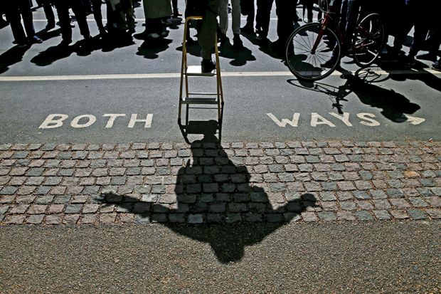A speaker casts a shadow as he addresses a crowd at Speakers’ Corner in Hyde Park, London