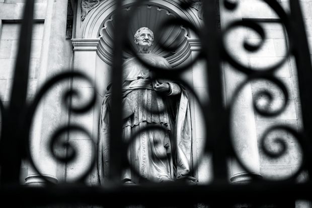 Statue behind a fence