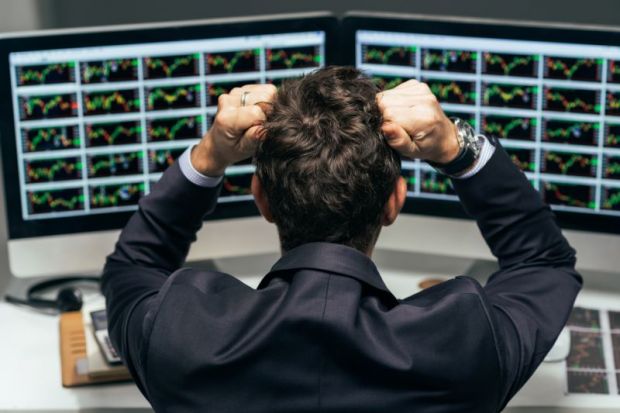 Stressed man looks at markets
