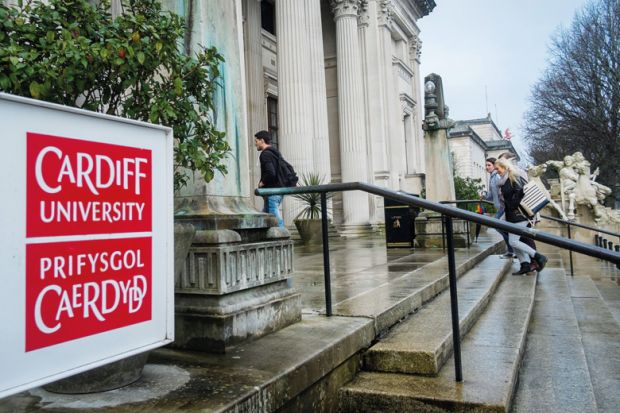 Students walking into Cardiff University campus building