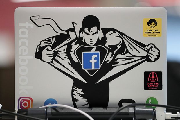 Superman sticker on Macbook computer