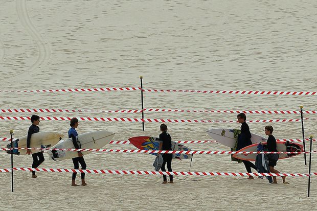 Surfers carry their boards on Sydney’s Bondi Beach after it reopened after a five week closure, autonomy, free from meddling