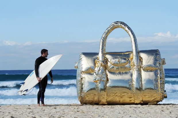 Surfer with a giant handbag