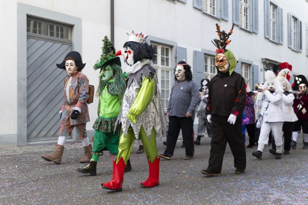 Switzerland, Basel, 8 March 2022. Small group of carnival participants in colorful costumes