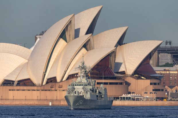 Sydney, Australia - October 5, 2013 HMAS Parramatta (FFH 154) Anzac-class frigate of the Royal Australian Navy in Sydney Harbor with the Sydney Opera House in the background.