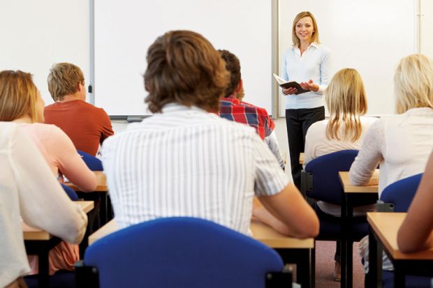 Teacher speaking at front of classroom