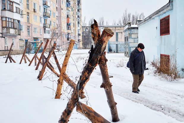 Man by fence in Ukraine