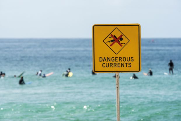 Dangerous currents warning sign on beach, Australia