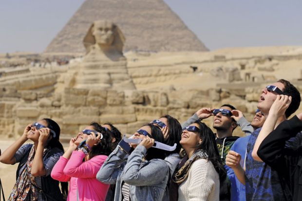 People viewing solar eclipse, Pyramids of Giza, Sphinx, Egypt