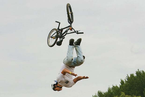 A BMX rider falls as he competes in the National Adventure Sports Show in Shepton Mallet, Somerset, south west England