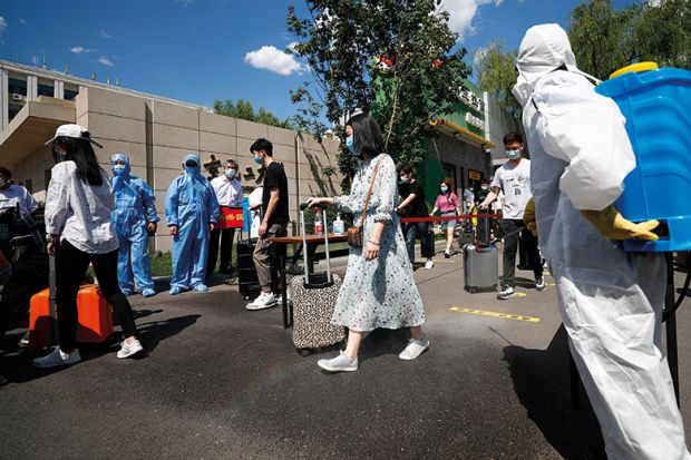 Teachers wearing face masks take part in a drill at Beijing University of Chemical Technology on May 27, 2020 in Beijing, China. The university carried out an epidemic prevention and control drill on Wednesday in preparation for its reopening. 