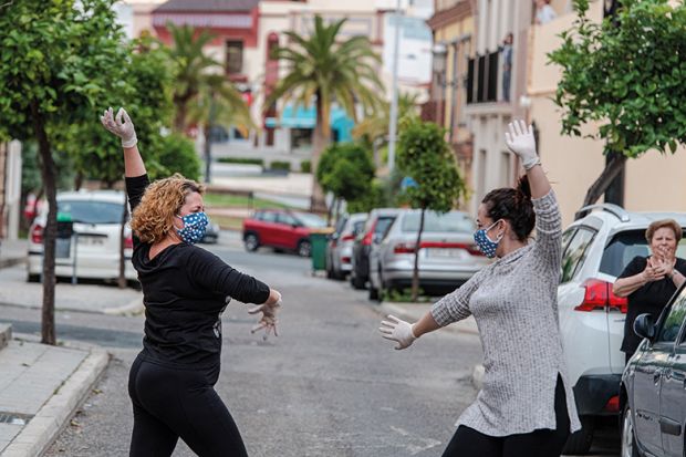 Locals wearing protective mask dance sevillana, a typical flamenco dance, in the street in front of their house April 24, 2020 in Mairena del Alcor, Spain during Covid-19 pandemic