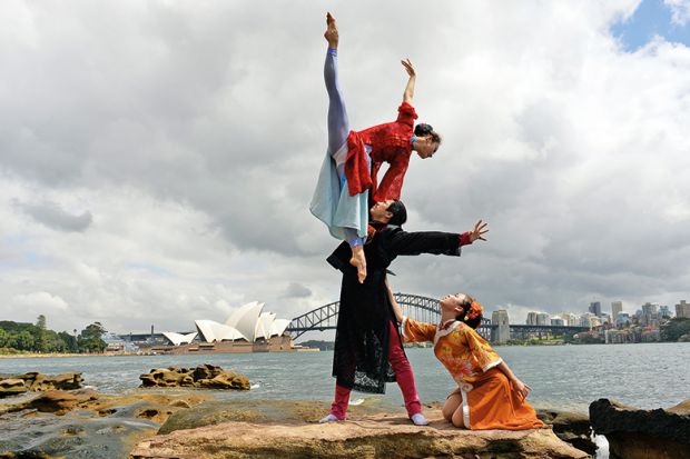 Performers from a Chinese ballet company perform in front of the Australia's iconic landmarks Opera House and Harbour Bridge in Sydney