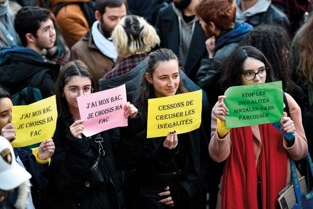 Students hold banners reading "I passed my high school diploma (Baccalaureat or Bac in French), I get to choose my university" and "Stop widening inequalities" during a demonstration march at Place Saint-Michel, Paris, France, on December 11, 2018
