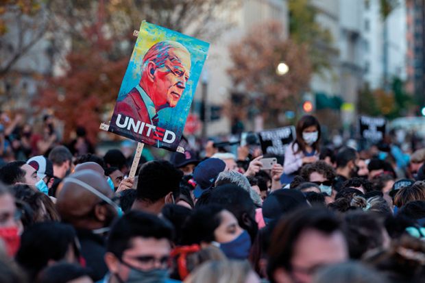 People celebrate at Black Lives Matter Plaza across from the White House in Washington, DC on November 7, 2020, after Joe Biden was declared the winner of the 2020 presidential election