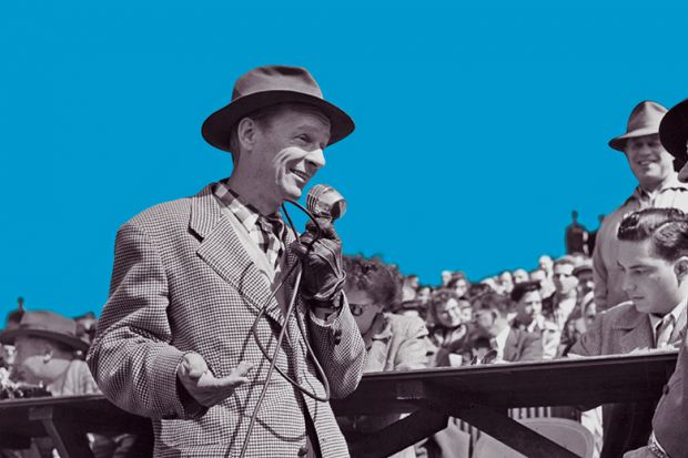A man wearing a hat speaks into a microphone addressing the crowd gathered behind him, USA, circa 1950. 