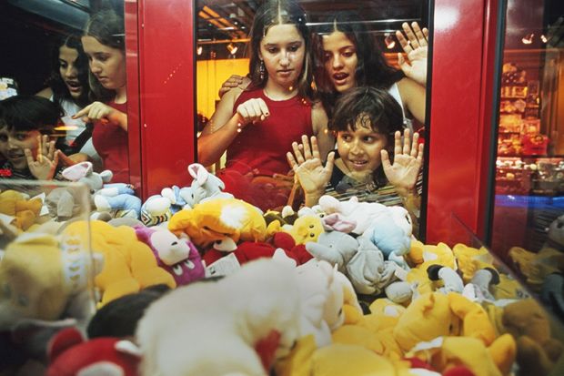 Children look at soft toys