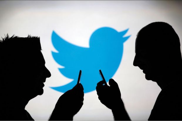 Men using smartphones against Twitter backdrop
