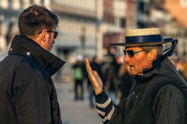 Two male gondoliers speaking, Piazza San Marco, Venice, Italy