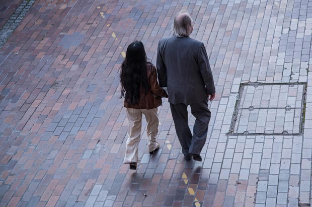 A man and a woman walking in the street