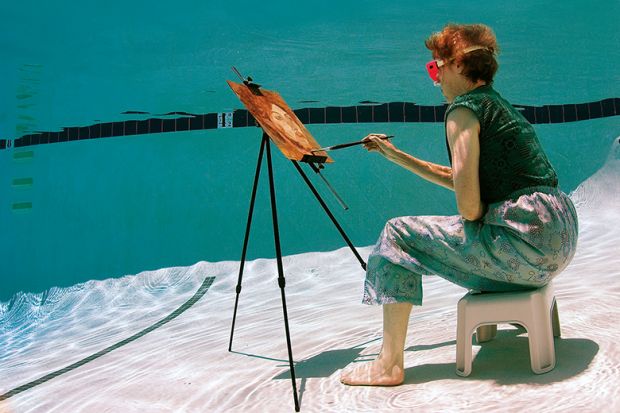 Woman painting underwater
