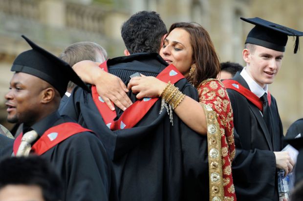 University graduates hugging and celebrating