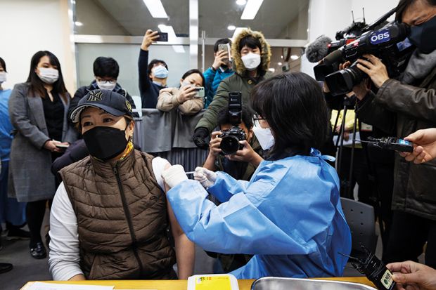 Media documents a nurse administering the AstraZeneca Covid-19 vaccine at a public health centre in Incheon, South Korea, in February 2021