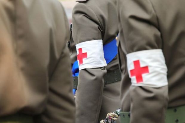 Vicenza, VI, Italy - June 2, 2022 Red cross symbol on the sleeve of the uniform of the army doctor soldiers