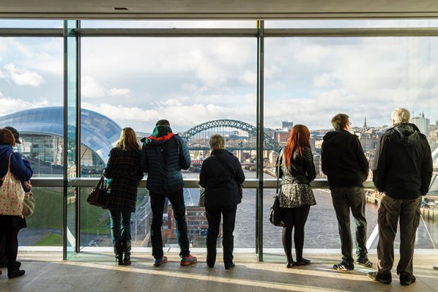 People looking out the window of the Baltic at the city view of Newcastle upon Tyne