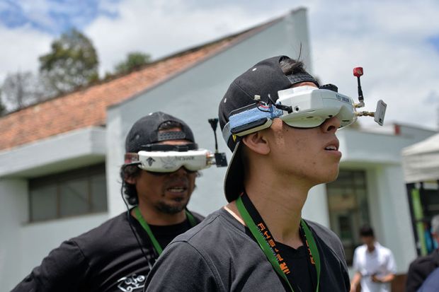 Two young men wear VR headsets