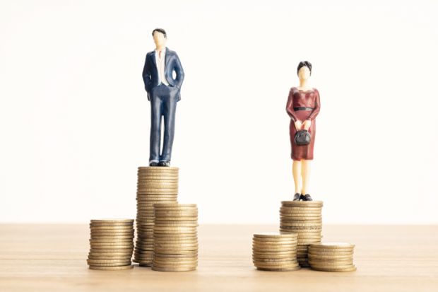 A woman stands on a lower pile of coins than a man, symbolising the gender wage gap