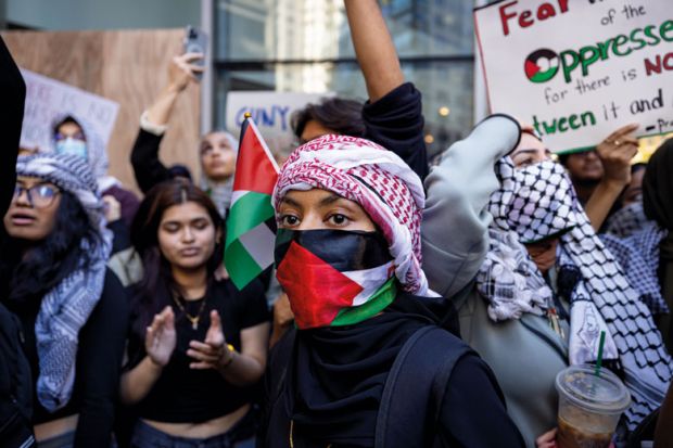 Students from Hunter College chant and hold up signs during a pro-Palestinian demonstration at the entrance of their campus to illustrate Israeli war revives academic freedom turmoil on US campuses