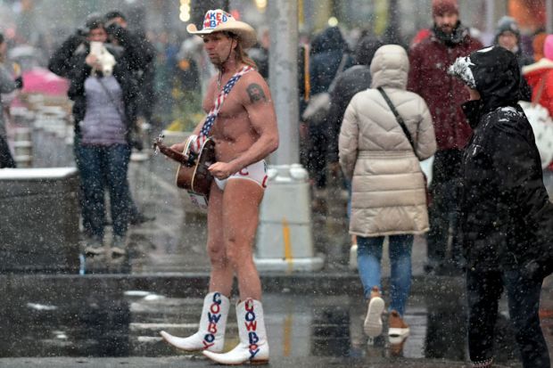 Street performer Naked Cowboy walks through the snow on Time Square to illustrate Open science funding cuts leave us ‘unprepared’ for next pandemic