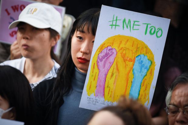 A demonstrator holds a sign reading "#Me Too" during a rally against sexual harassment in Shinjuku, Tokyo to illustrate Japanese universities ‘behind the times’ on sexual harassment