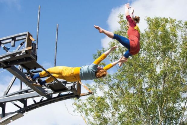 Performers launch themselves off the Imagineer Bridge in Warwick to illustrate ‘Contagion’ risk if UK university goes under, warns report