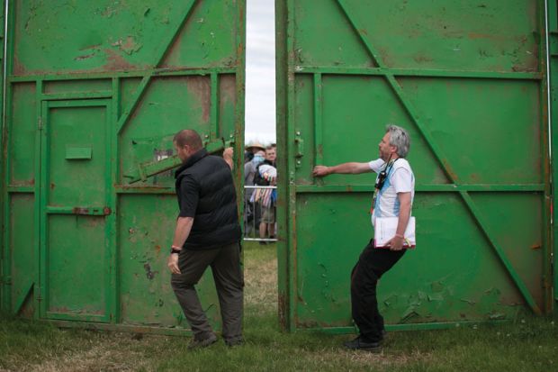 Stewards open the gates to ticket holders at a festival