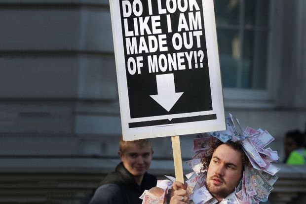 Student holds a placard dressed in bank notes to illustrate Conflict on many fronts