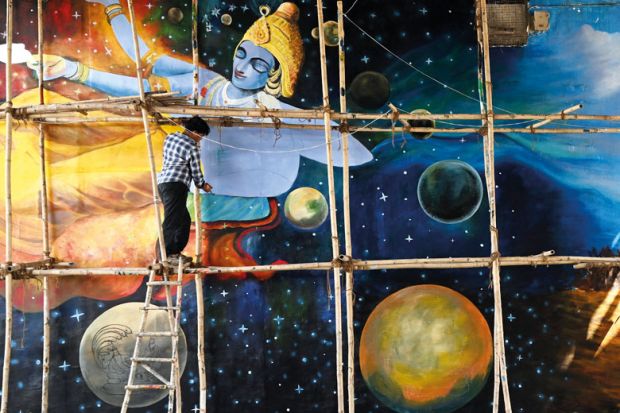 An artist gives final touches to a mural painted under a bridge in New Delhi to illustrate High hopes, low expectations for India’s ‘dream’ research funder